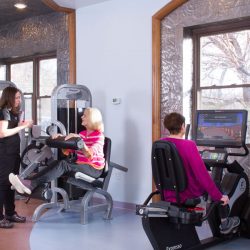 Patients and physical therapist working in the gym